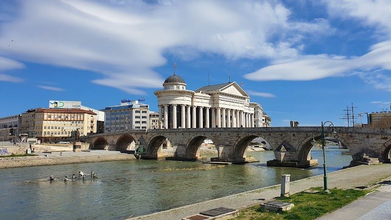 Walk across the Stone Bridge and visit Macedonia Square